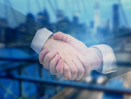 Close-up view through window of lawyers shaking hands in partnership