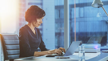 ERISA female Attorney working on liens at desk